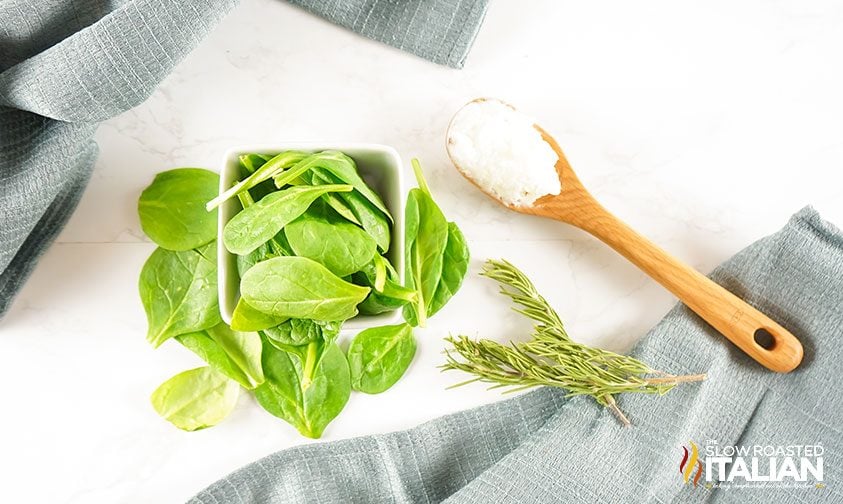 fresh rosemary and spinach on counter