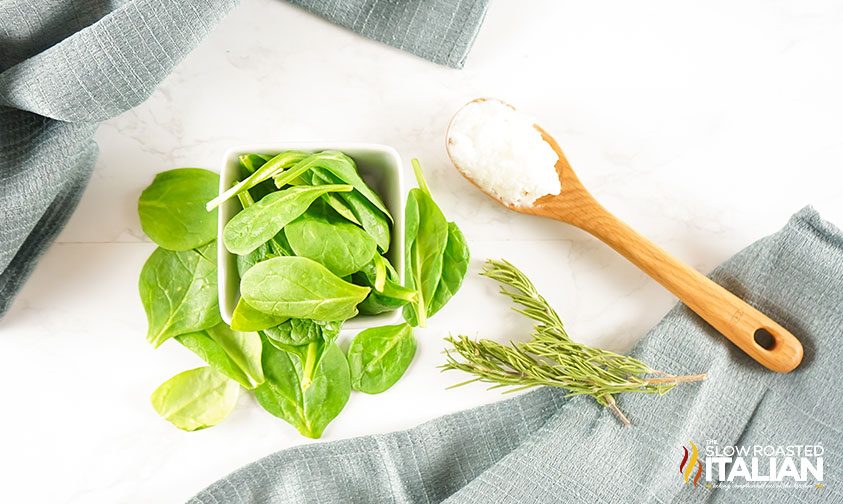 fresh rosemary and spinach on counter