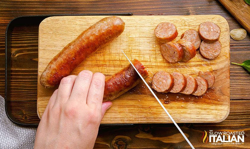 slicing sausage on a cutting board