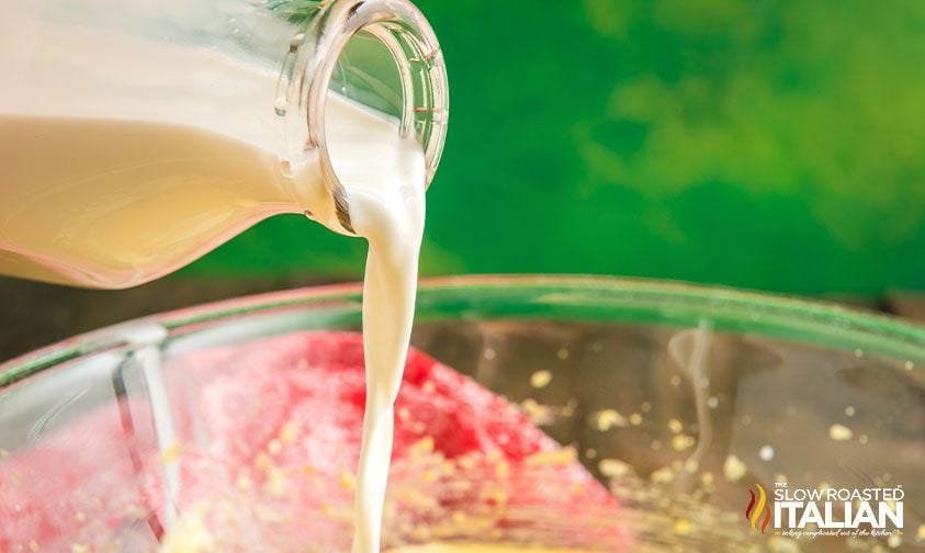 adding cream to mixing bowl