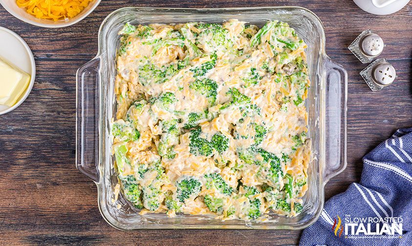 easy broccoli casserole in glass pan, ready for baking