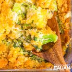 broccoli florets with cheese on wooden spoon