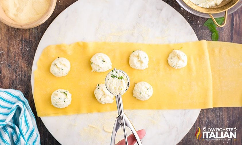 cheese ravioli rolled out and topped with mounds of ricotta