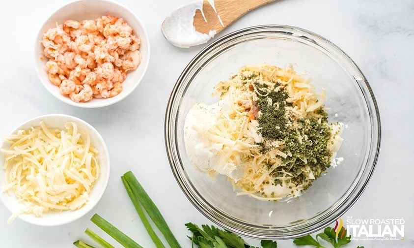 cream cheese shrimp dip being mixed in a bowl