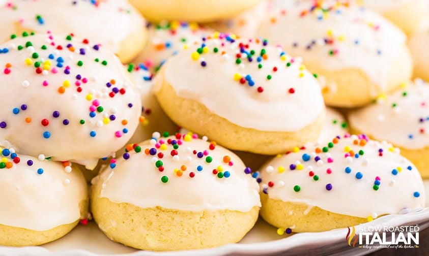 plate of frosted cookies with sprinkles