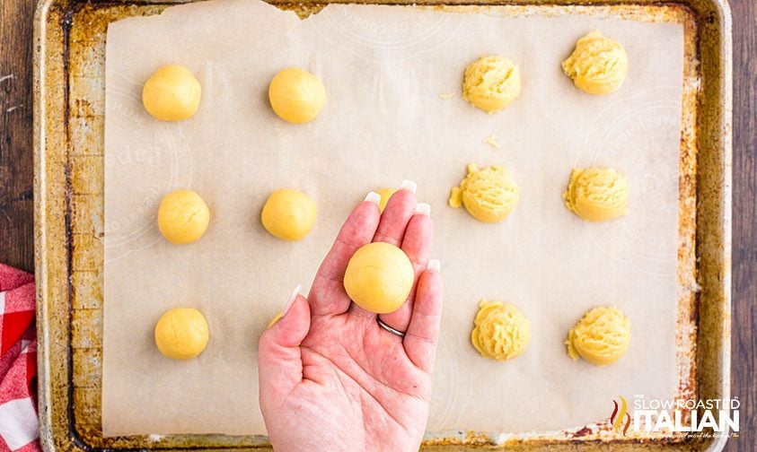 balls of unbaked cookie dough on parchment paper
