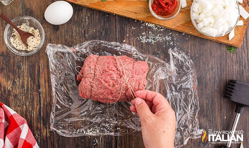 tying uncooked beef braciole with kitchen twine