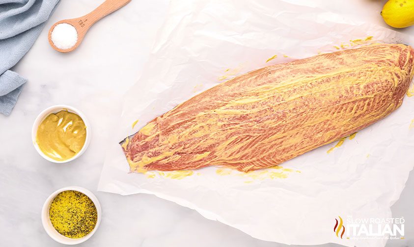 raw fish filet coated with mustard rub