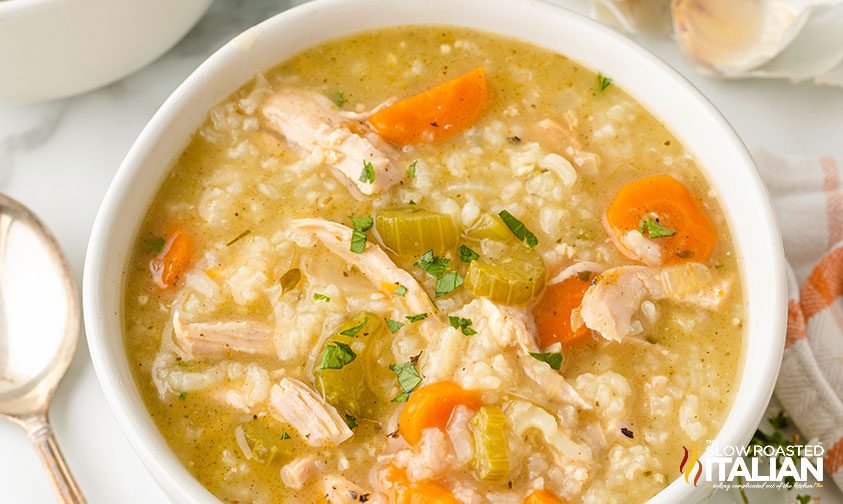 rice and turkey soup in a white bowl