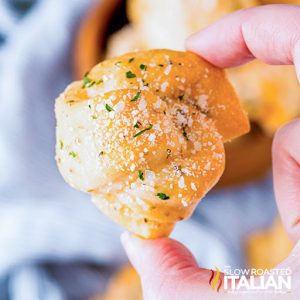 fingers holding soft garlic bread