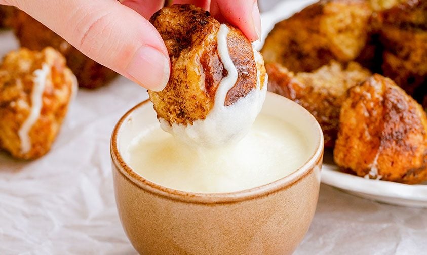 dipping cinnamon roll monkey bread in sauce