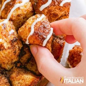 taking a piece of the cinnamon roll monkey bread