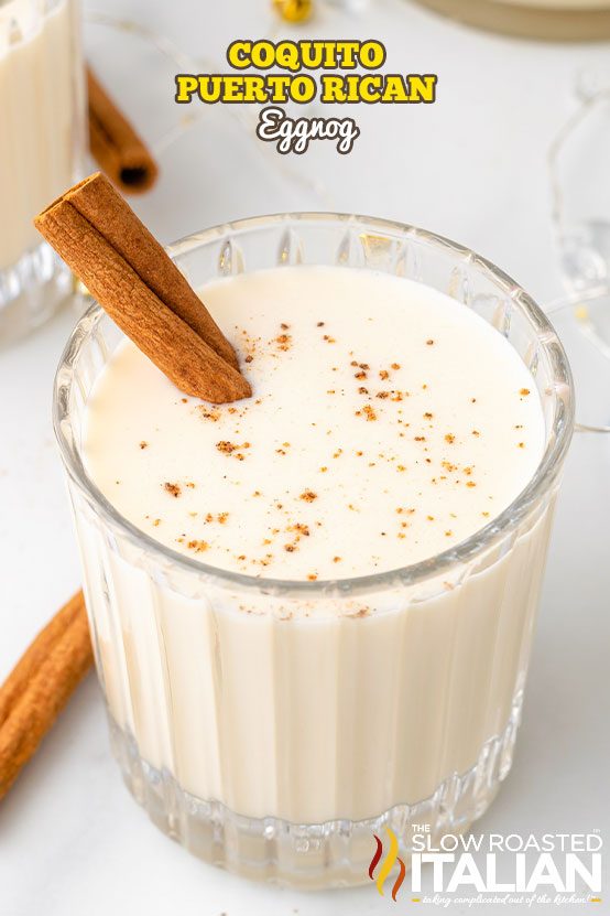 coquito in a glass with cinnamon stick