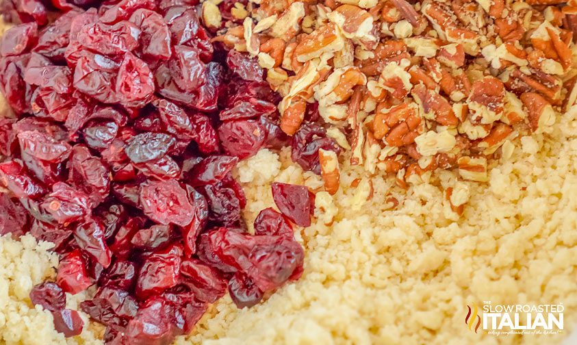 dried fruit and chopped nuts in bowl of cookie dough