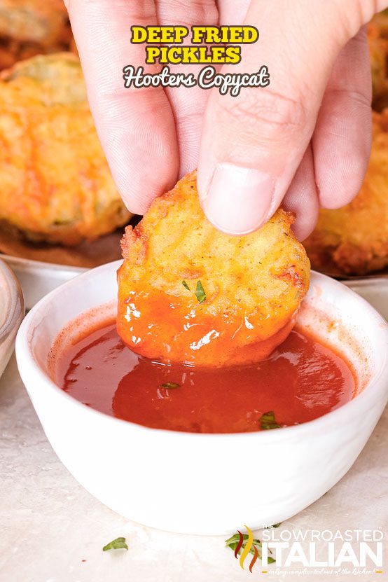 deep fried pickles dipping in sauce