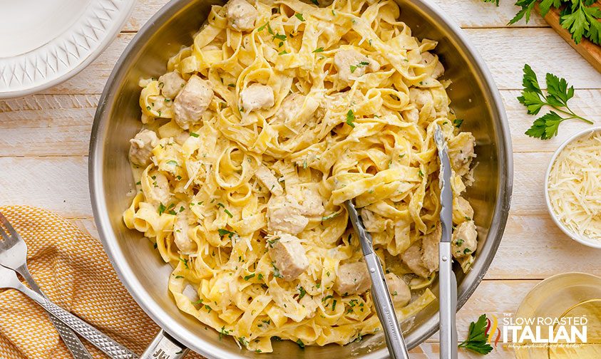 homemade chicken alfredo in a stainless steel skillet