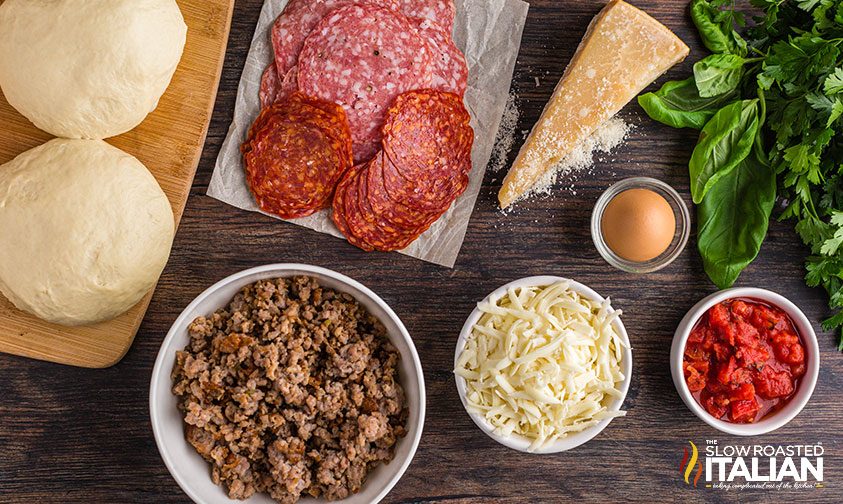 italian stromboli ingredients in bowls on counter