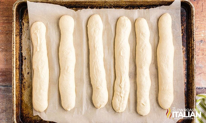 unbaked breadsticks dough on baking pan