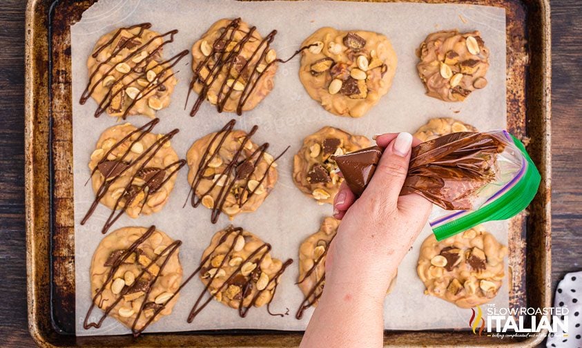 drizzling chocolate over homemade chocolate peanut butter candy