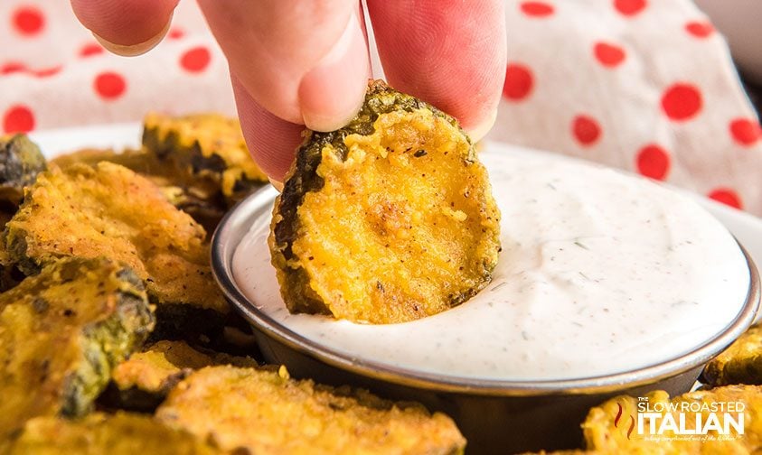 closeup: dipping deep fried pickles in ranch dressing