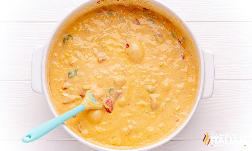 spoon in bowl of baked queso dip
