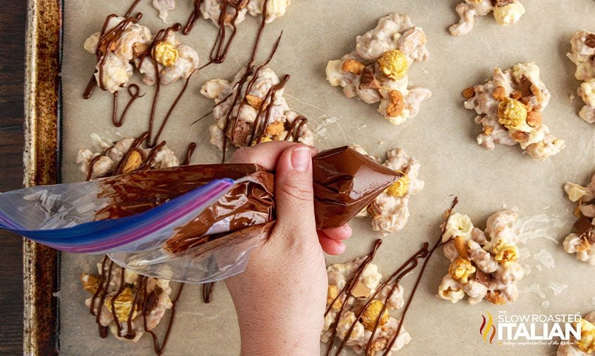 drizzling chocolate over slow cooker candy pieces