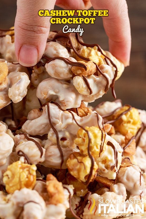 woman's hand holding piece of cashew toffee candy