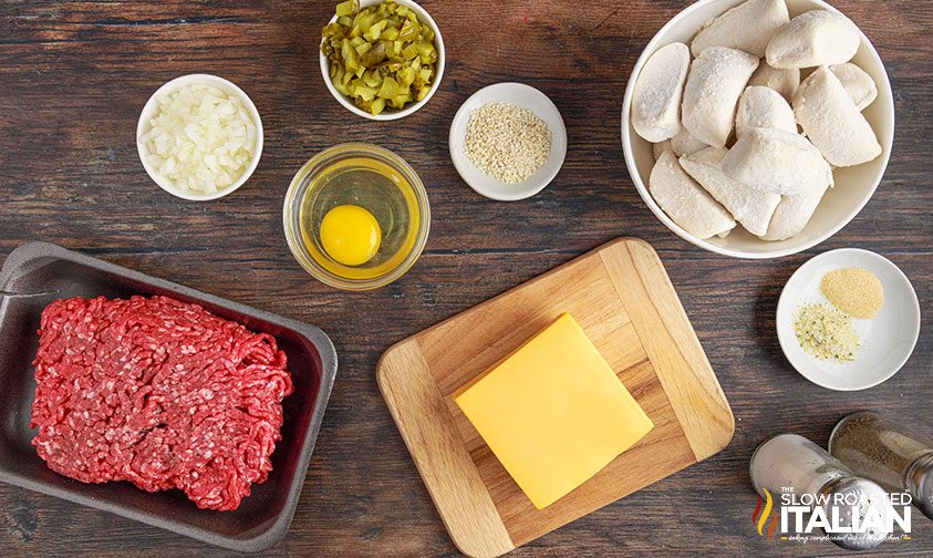 cheeseburger bombs ingredients in small prep bowls and on wooden cutting board