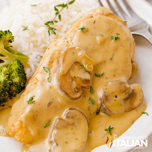 mushroom sauce covering meat on plate next to broccoli and white rice