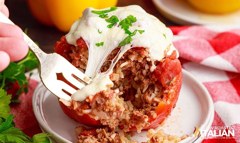 fork digging into stuffed bell pepper with rice and beef