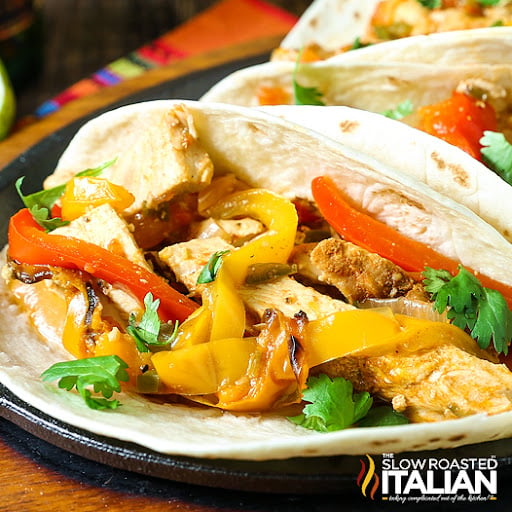 strips of white meat with colorful bell peppers in flour tortilla