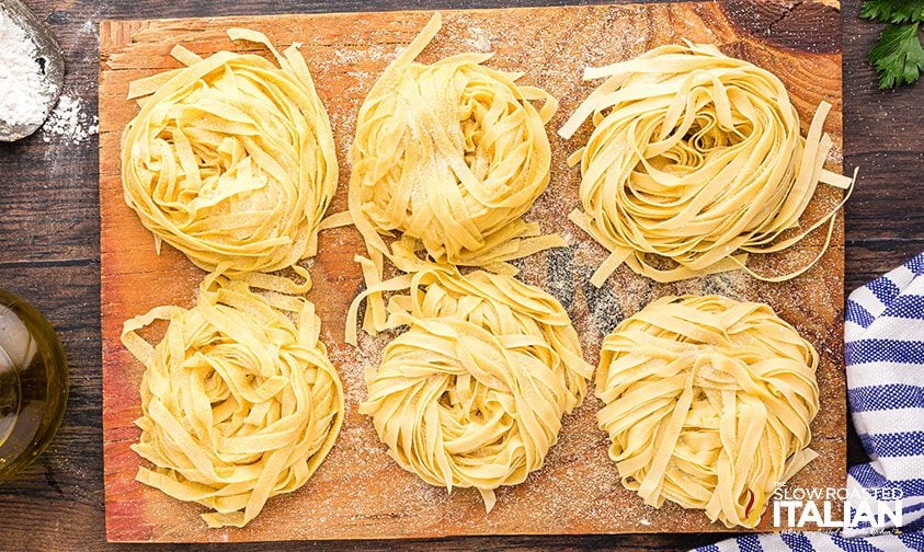 freshly made noodles in piles on counter top