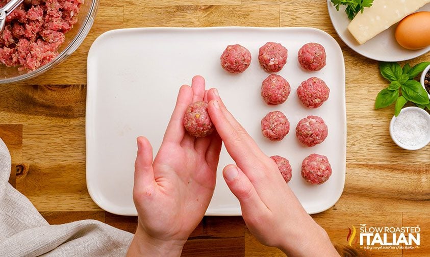 woman's hands rolling ground beef mixture in her hands