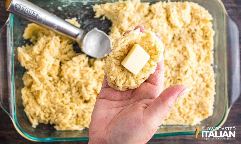 arancini rice balls flat with cube of cheese on top of rice