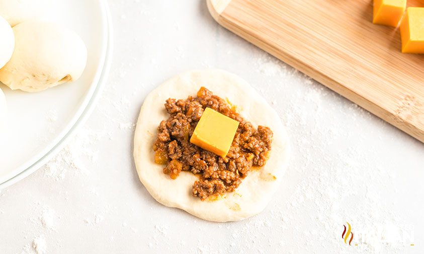 sloppy joes mixture on circle of bread dough