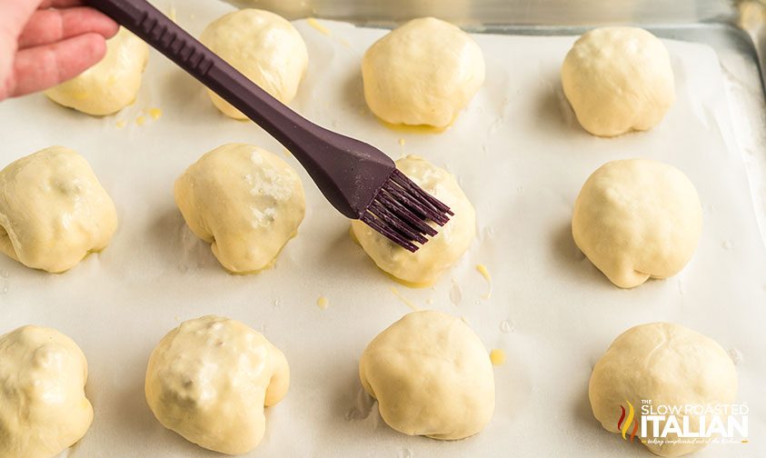 brush egg wash onto pretzel bread rolls