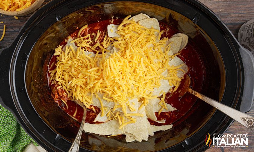 stirring cheese into other ingredients for slow cooker enchilada casserole