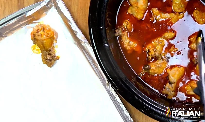 hot wings being put on a pan