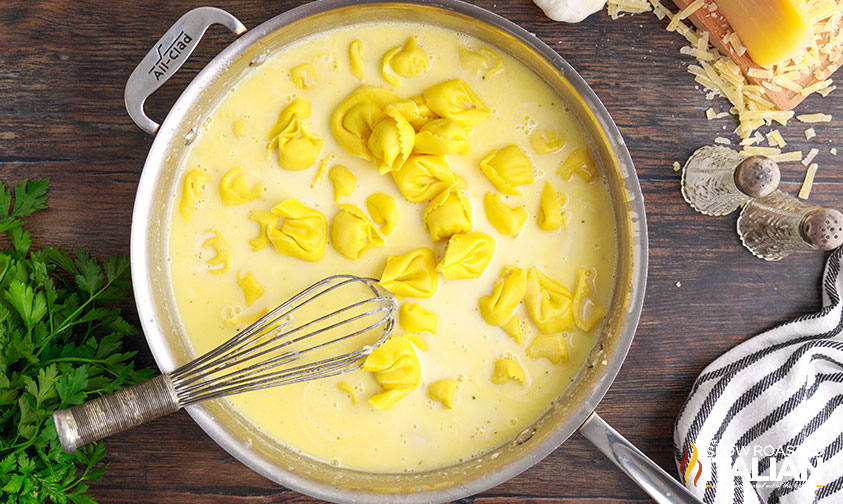 adding tortellini to sauce