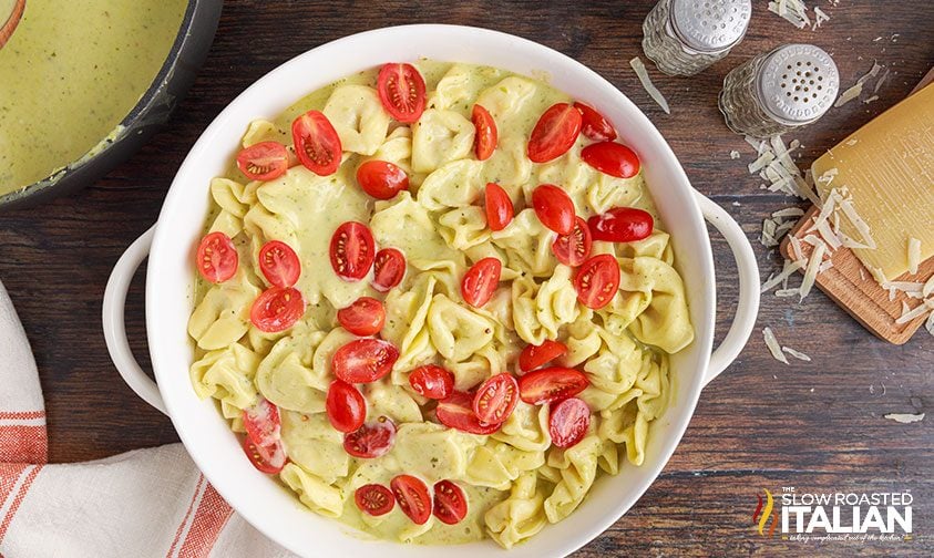 pesto tortellini in casserole dish ready to bake