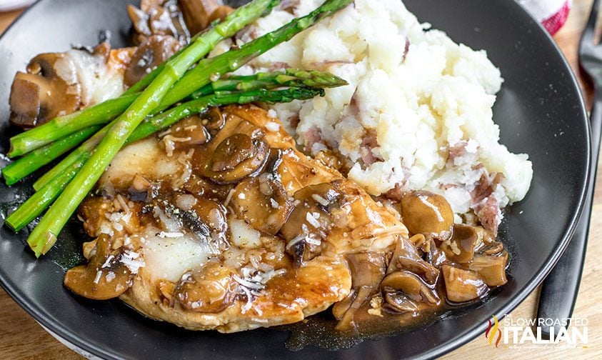 cheesecake factory chicken madeira on plate with asparagus and mashed potatoes