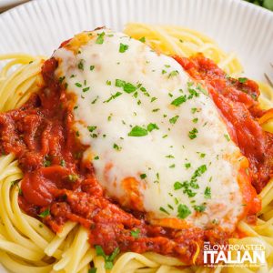 cheese covered chicken on spaghetti