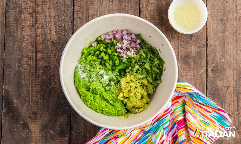 ingredients in bowl for healthy guacamole with peas