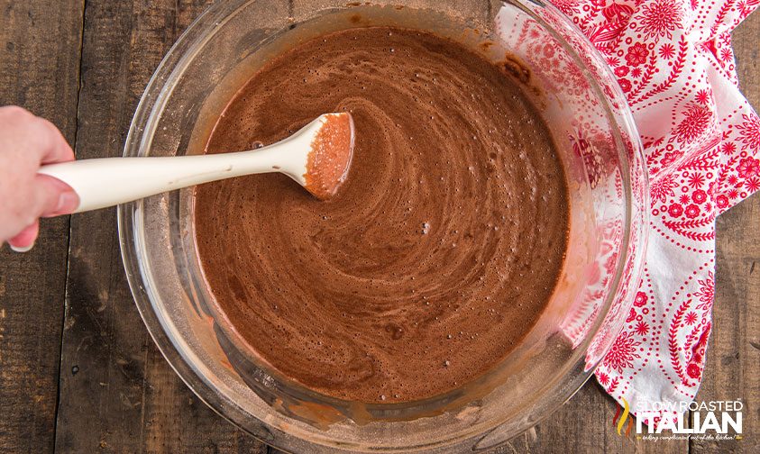 wooden spoon in bowl of cake batter