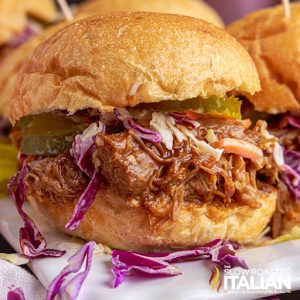 shredded meat on bun with red cabbage slaw