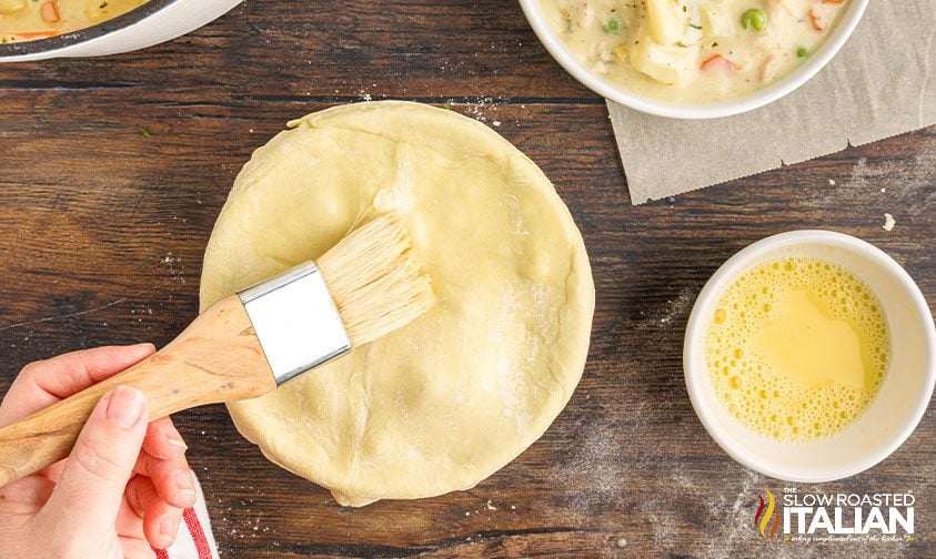 brushing egg wash onto pot pie crust