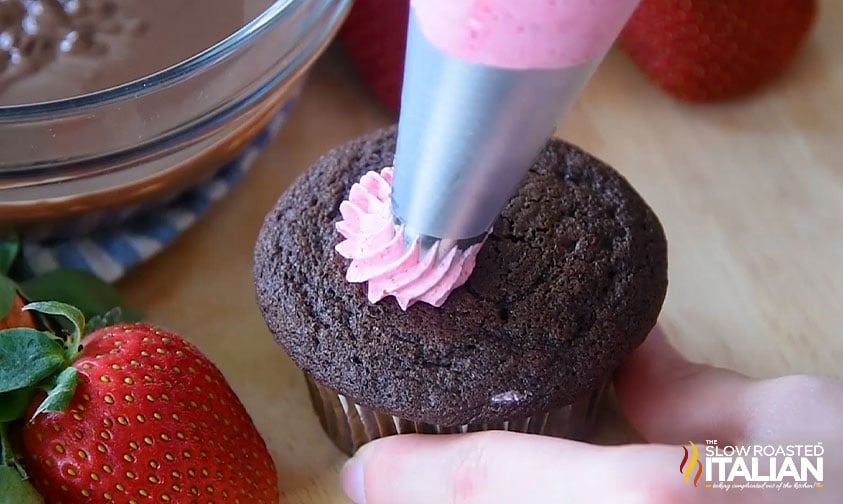 piping icing on brownie cupcakes