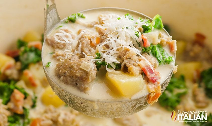 ladle with sausage and potatoes in italian soup