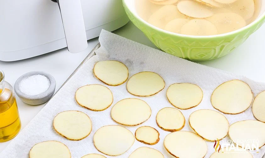 drying potato slices on baking sheet lined with paper towels