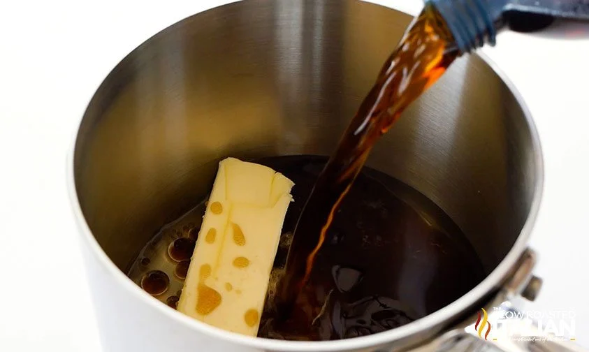 adding coca cola to saucepan with butter